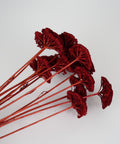 A cluster of artificial deep red ginkgo leaves with long reddish-brown stems, arranged on a plain light gray background.